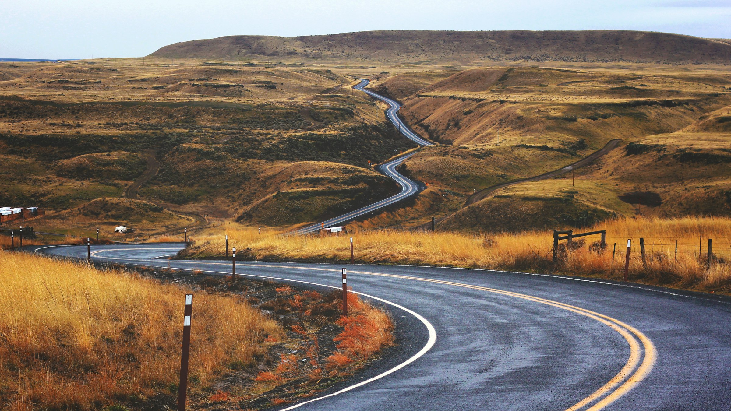 An open road stretching ahead through wide-open countryside